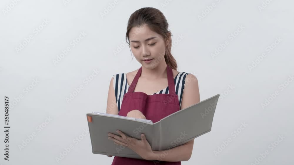 4K footaage of Portrait of Asian entrepreneur holding business folder smiling then jod note and check document on the folder, new startup business, Creativity freelancer, cafe business, woman owner. 4K footaage of Portrait of Asian entrepreneur holding business folder smiling then jod note and check document on the folder, new startup business, Creativity freelancer, cafe business, woman owner.