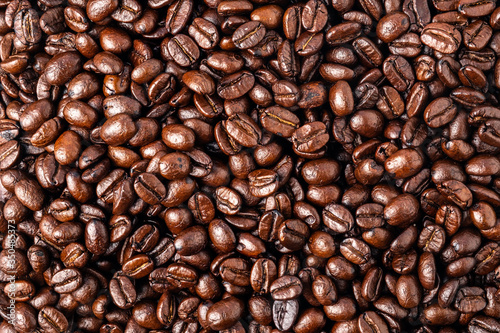 Piled roasting coffee beans backgrounds. Top view