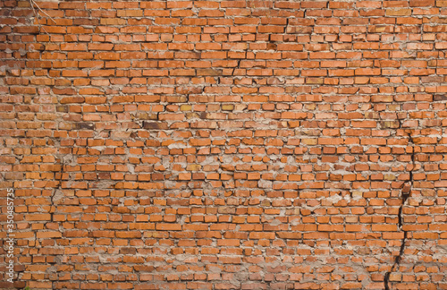 Old red brick wall as background.