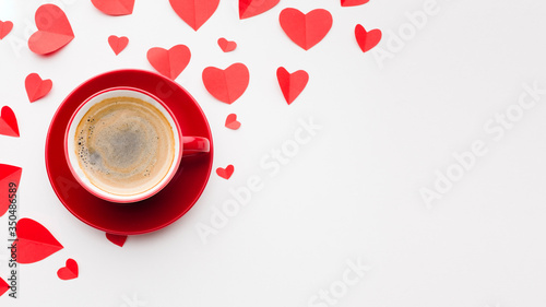 Top view of coffee and paper heart shapes for valentines day