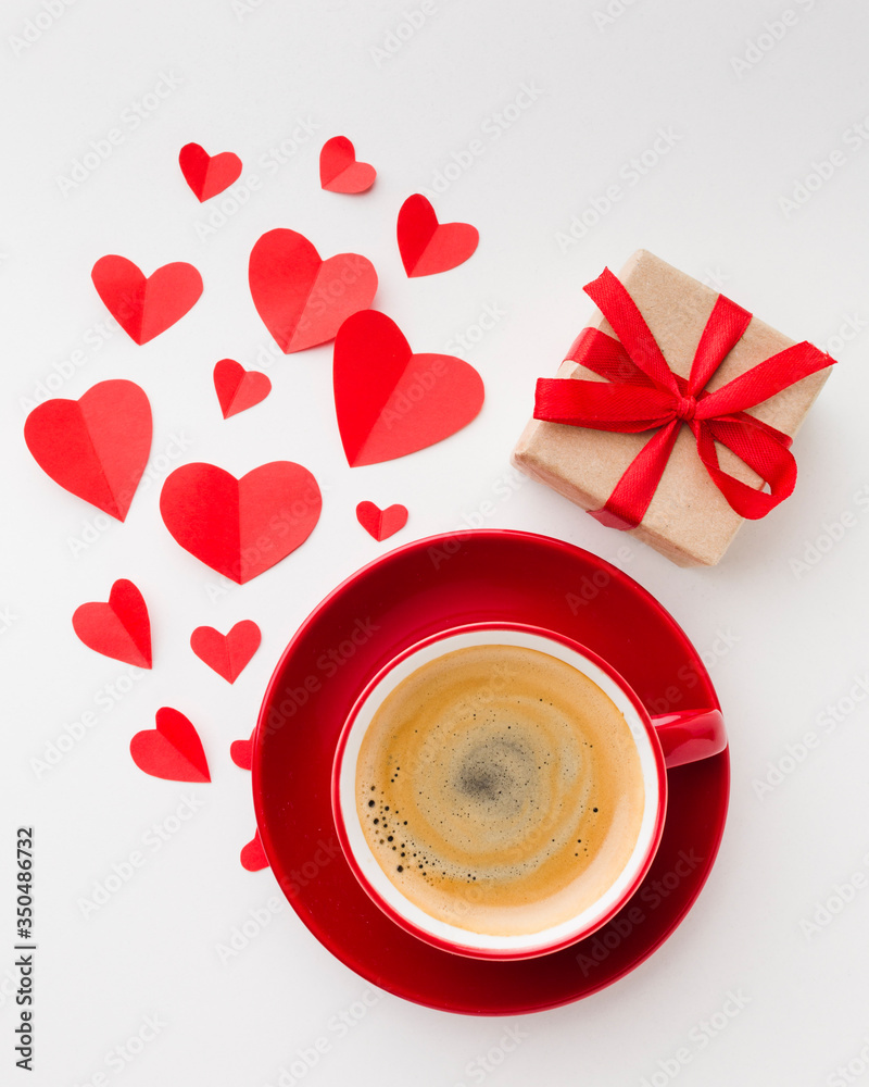 Flat lay of cup of coffee with valentines day present