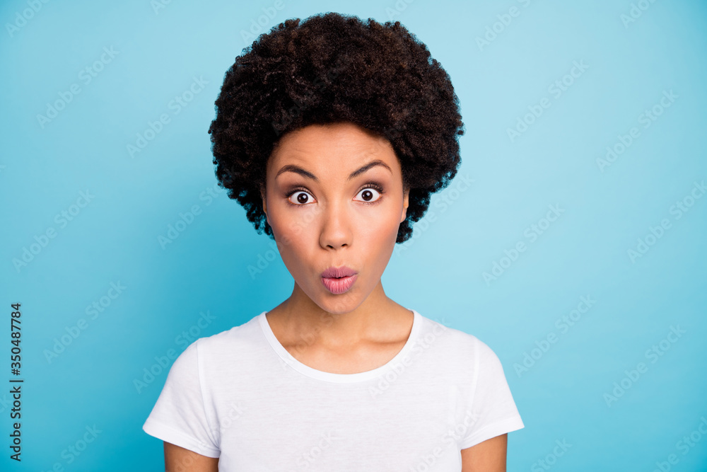 Closeup photo of amazing pretty dark skin wavy lady open mouth listen unexpected good news can't say word stupor wear casual white t-shirt isolated blue color background Closeup photo of amazing pretty dark skin wavy lady open mouth listen unexpected good news can't say word stupor wear casual white t-shirt isolated blue color background