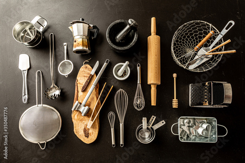 Kitchen utensils (cooking tools) on black chalkboard background photo