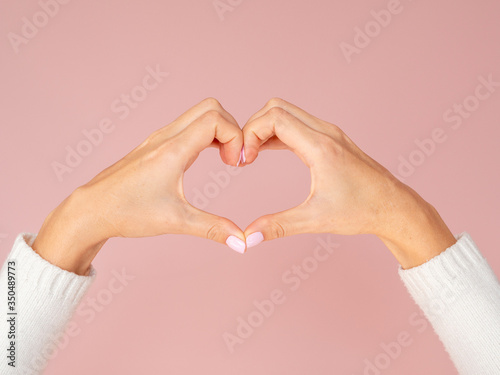Front view hands showing heart gesture