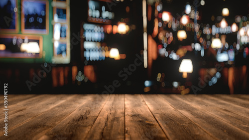 wooden table in front of abstract blurred background,3d rendering,conceptual image.