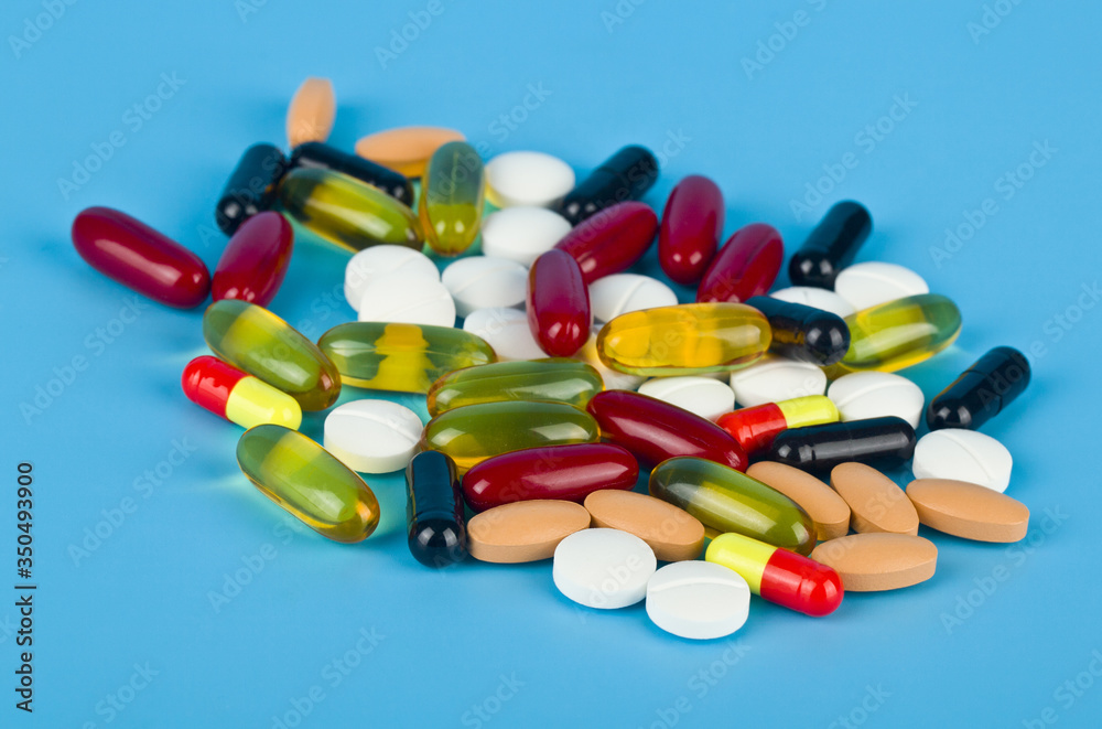 Pills on a blue background close-up. Pills on a blue background close-up.
