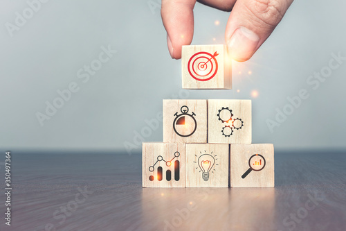 Hand arranging wood block stacking as step stair on table. Successful business steps, Business development Decide and choose concept.The left space for your content.