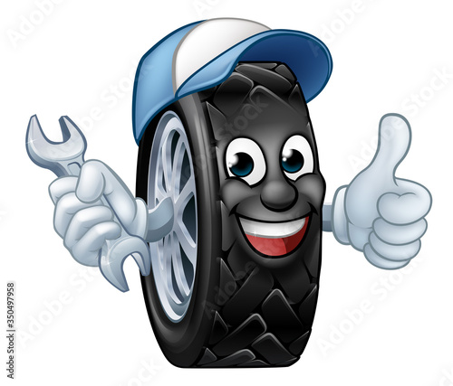 A tyre cartoon car mechanic service mascot holding a spanner and giving a thumbs up