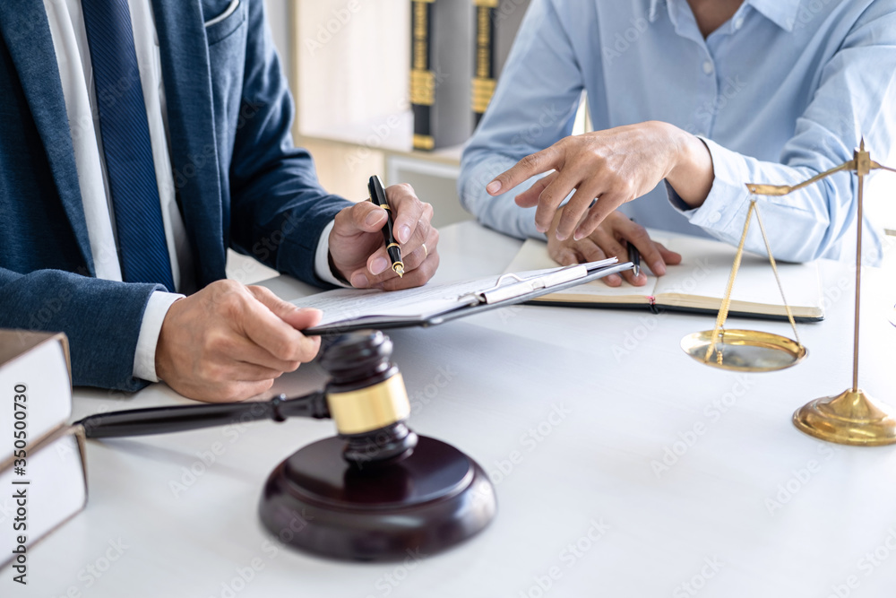 Businesswoman and Male lawyer or judge consult and conference having team meeting with client at law firm in office, Law and Legal services concept Businesswoman and Male lawyer or judge consult and conference having team meeting with client at law firm in office, Law and Legal services concept