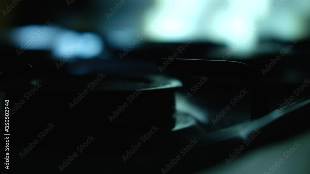Turning on the cooktop gas cooker. Kitchen burner turning on. A man puts a metal bucket on a stove Turning on the cooktop gas cooker. Kitchen burner turning on. A man puts a metal bucket on a stove