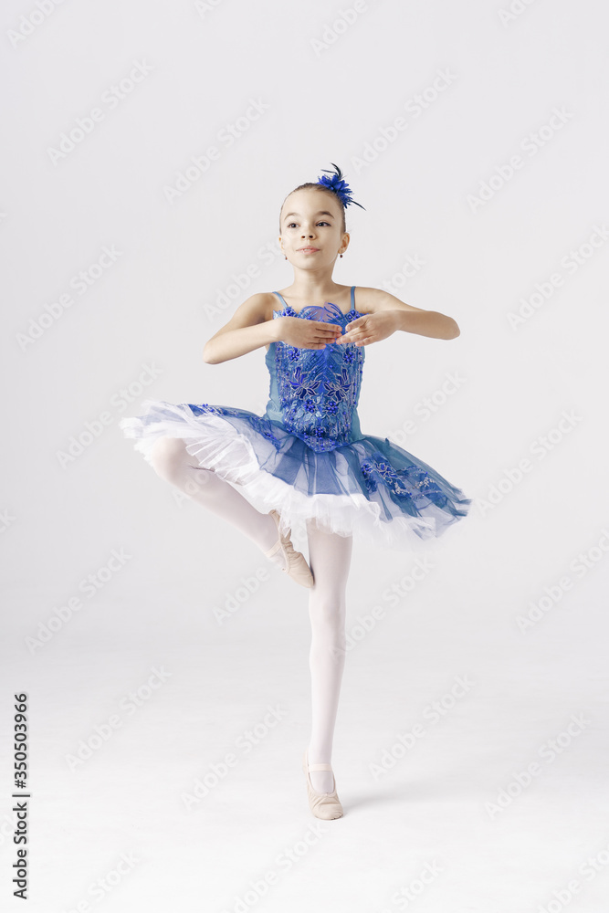 Beautiful preteen girl ballerina wearing a princess dress, winter fairy dancing over white background Beautiful preteen girl ballerina wearing a princess dress, winter fairy dancing over white background