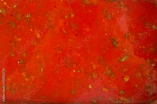 Closeup texture red tomato sauce with herbs © Hihitetlin
