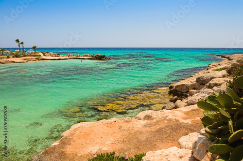 Mediterranean coast with a rocky coast and turquoise sea and people