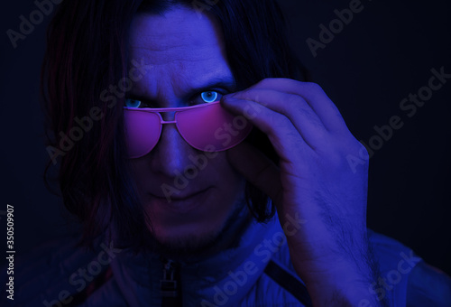Retro wave portrait of cyborg young man with glowing eyes. © Alex Photo