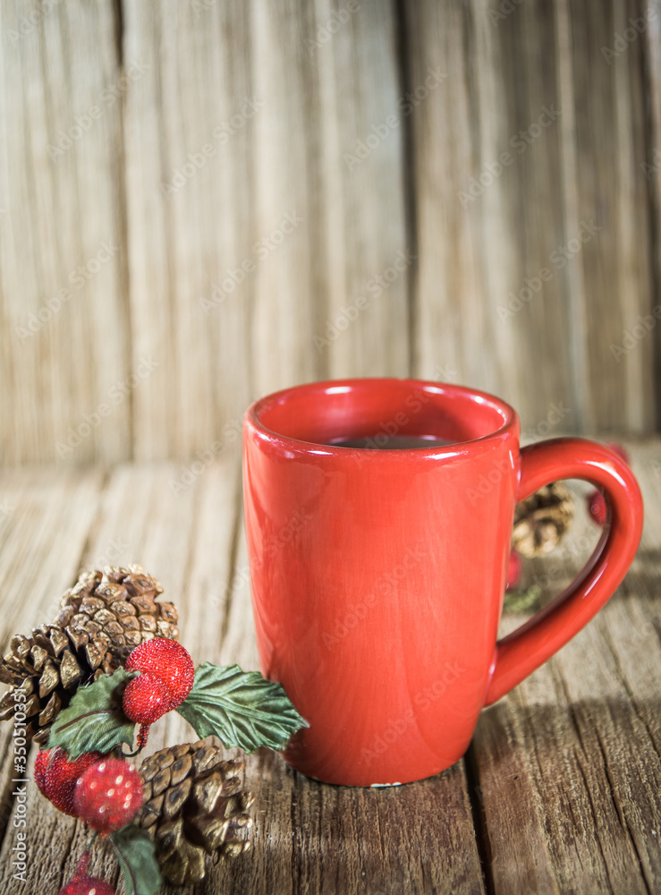 Φωτογραφία a red cup of coffee with Christmas ornament on the old wooden table top with wood panel background
