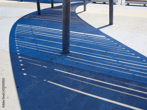Modern futuristic design metal pergola arbor cast shadow on the ground