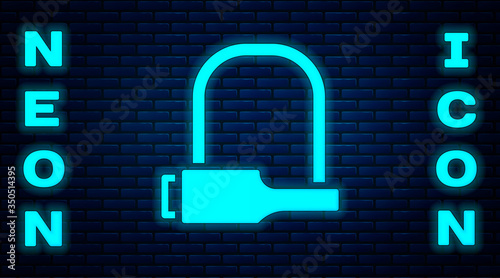 Glowing neon Bicycle lock U shaped industrial icon isolated on brick wall background. Vector