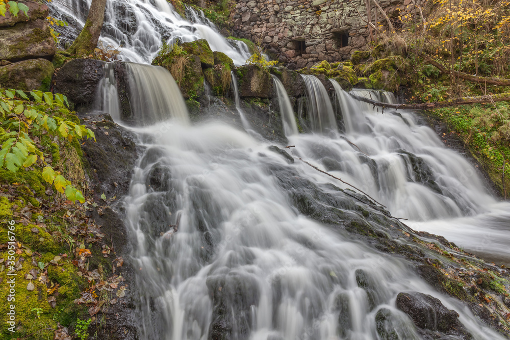 Obraz premium A waterfall in a forest in central Sweden photographed by a long exposure.