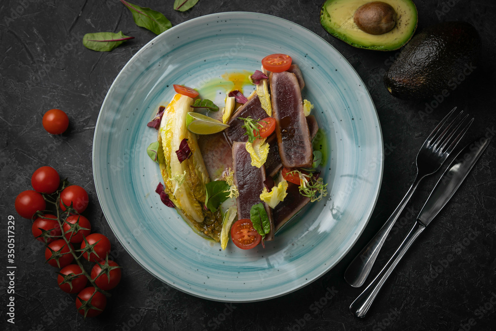 tuna salad and avocado on black background tuna salad and avocado on black background