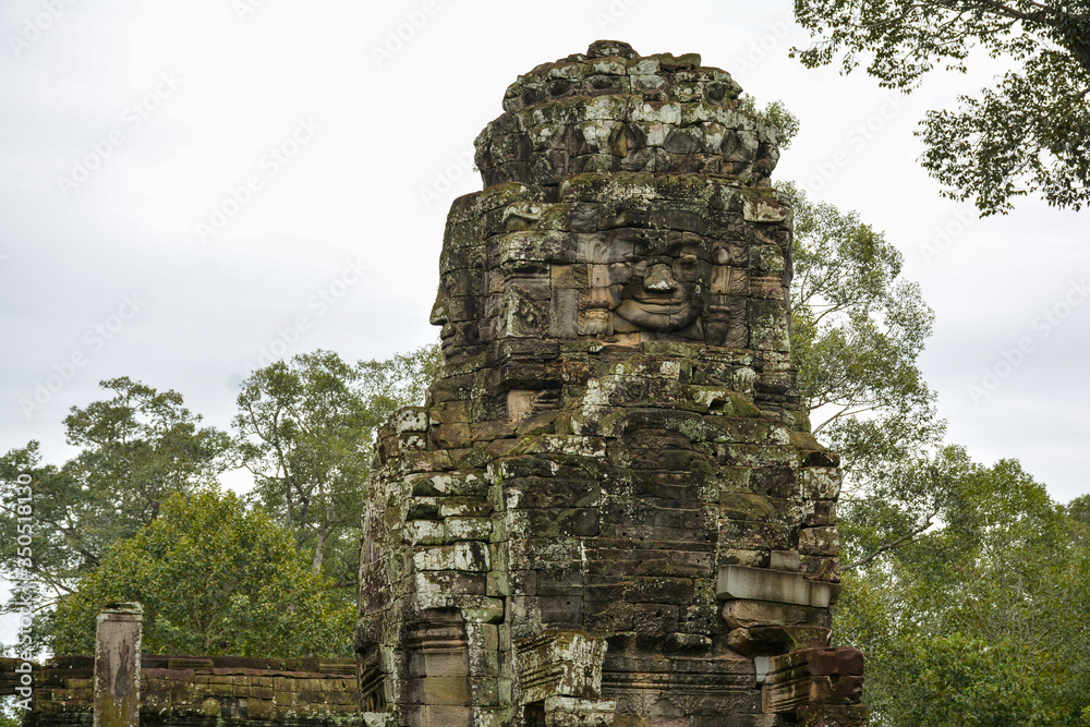 Stone faces carved in a tower of Bayon Temple, Cambodia. Ancient city of Angkor Thom near Siem Reap, Cambodia 