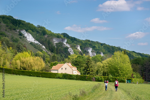 Canvas Print People hiking near a cliff close to river Seine and the village of La Roche Guyo