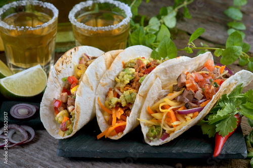 Tacos with different fillings and tequila