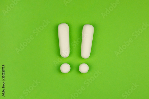 Two exclamation marks on green background. Keep attention concept, warning. Important information.