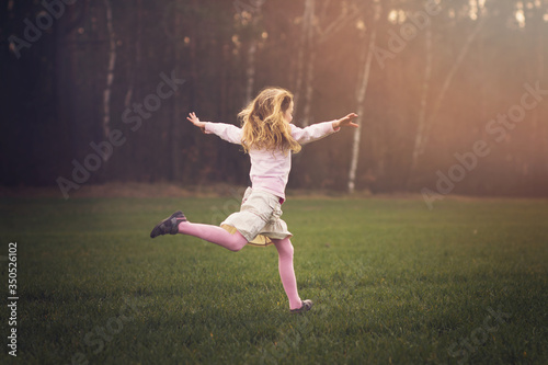 young girl is running in the nature  spring concept