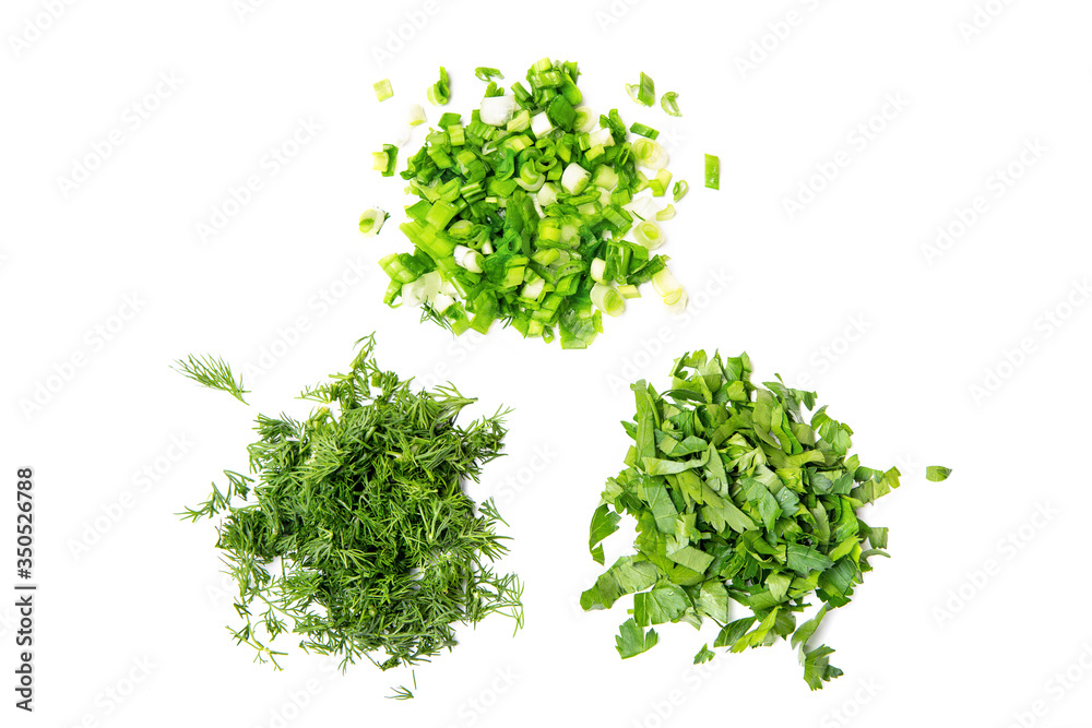 A handful of chopped green onions, parsley and dill. White isolated background. A handful of chopped green onions, parsley and dill. White isolated background.