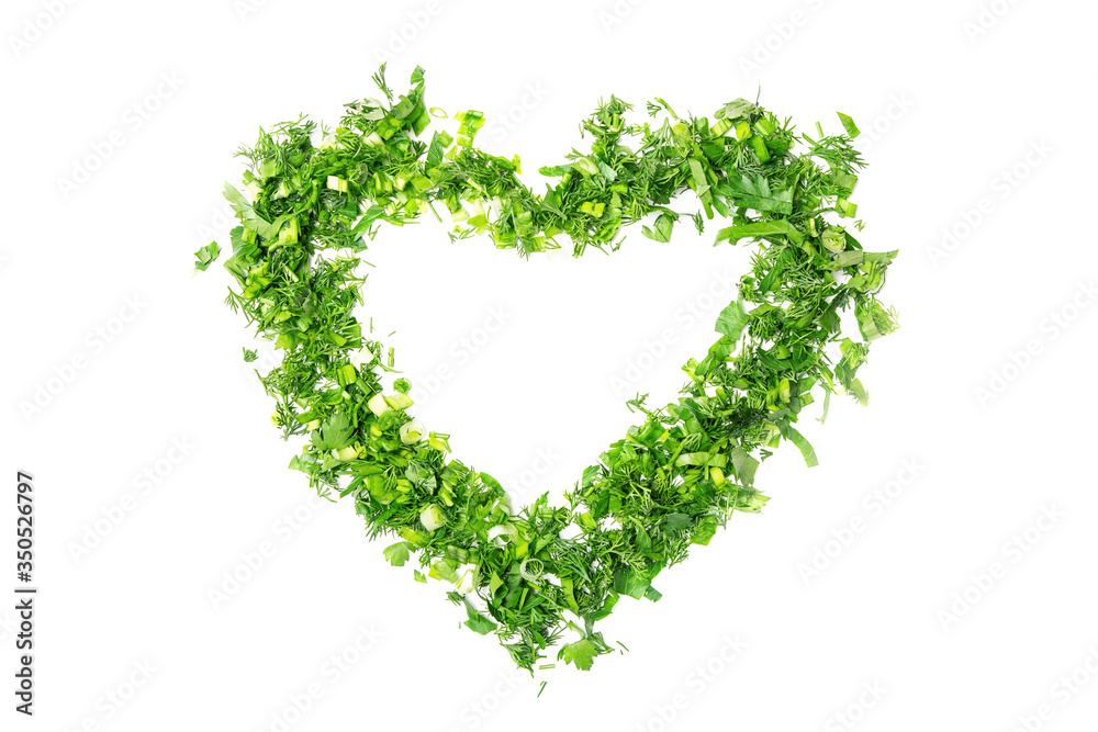The heart shape is made of chopped green onions, parsley and dill. White isolated background.