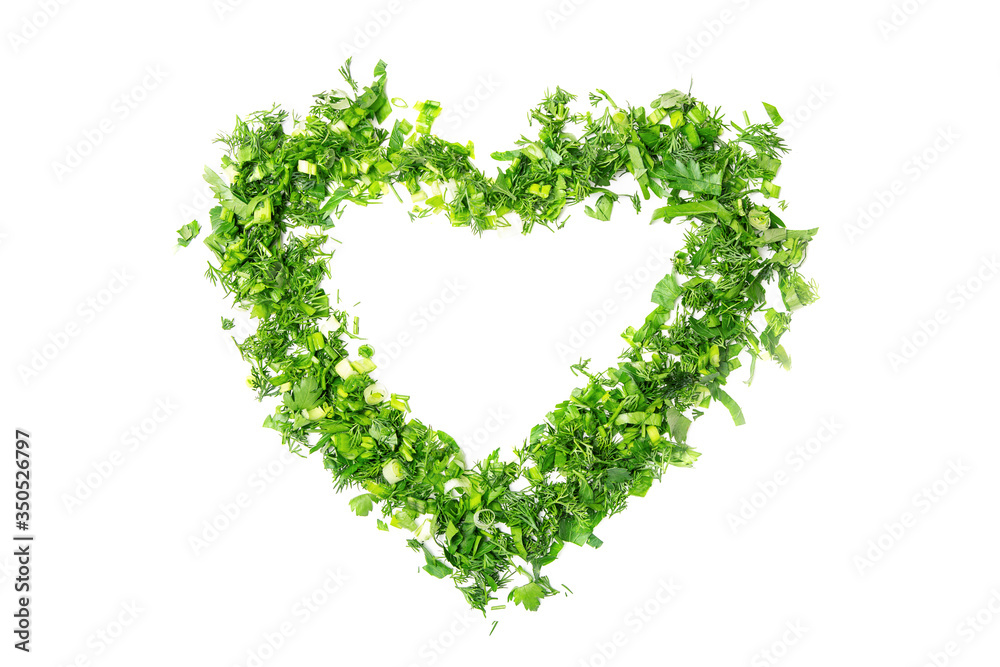 The heart shape is made of chopped green onions, parsley and dill. White isolated background. The heart shape is made of chopped green onions, parsley and dill. White isolated background.