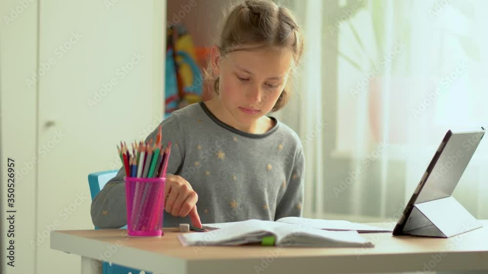 Cute child use laptop for education, online study. Girl has homework at home schooling. Lifestyle concept for Family quarantine covid-19. Cute child use laptop for education, online study. Girl has homework at home schooling. Lifestyle concept for Family quarantine covid-19.