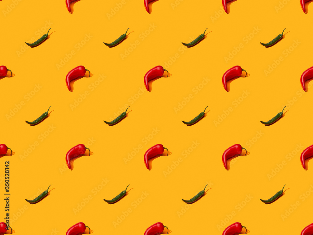 red spicy chili peppers and jalapenos on orange colorful background, seamless pattern