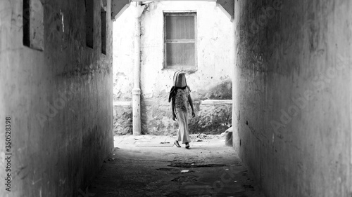 young girl with bag ober her head in Stonetown © SearchingForSatori