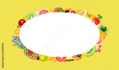 Creative photo of many different exotic tropical bright fruits on a yellow background and an isolated white oval with beautiful jagged edges in the center for text. Bright summer fruit pattern.