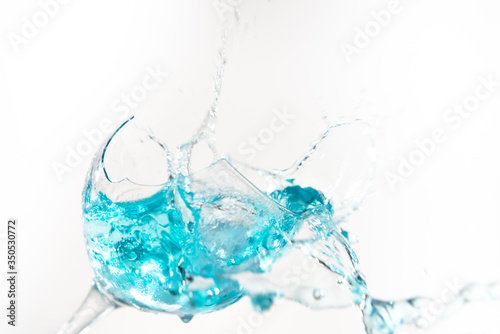 Water splashing into a broken glass