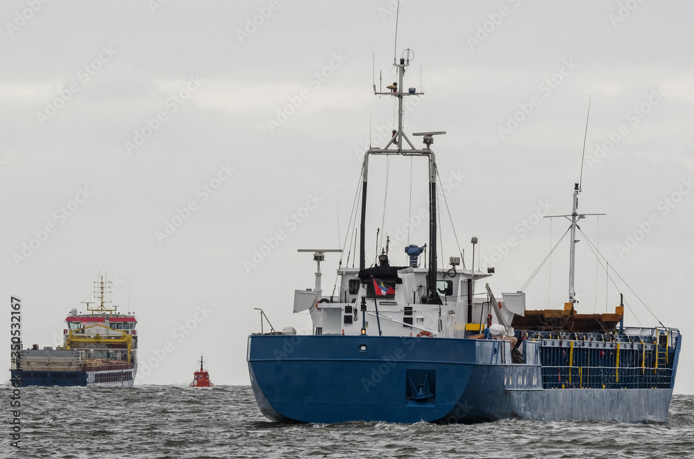 Naklejka premium MARITIME TRANSPORT - Freighters are sailing on a sea voyage 