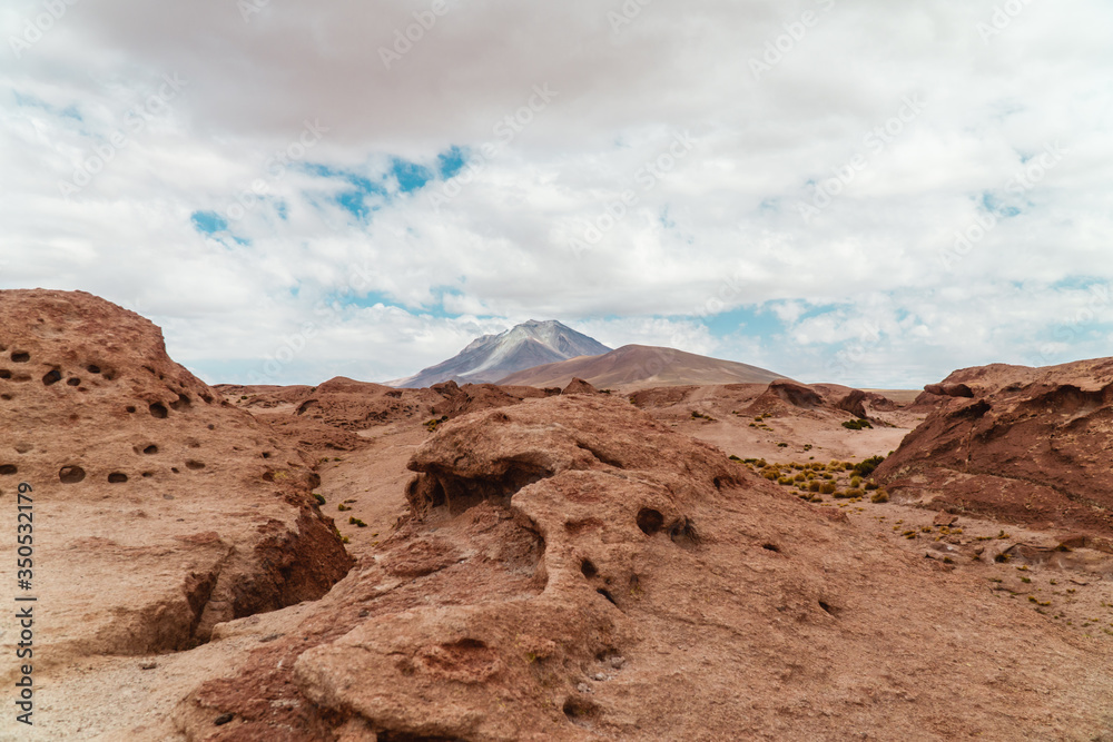 Rocky landscape mountain background. Dry, Barren desert, snowcapped mountains wilderness. Mountain range view. Salt Flats of Uyuni, Bolivia. Copy space, Rocks, blue sky, nature, hiking, sand dust