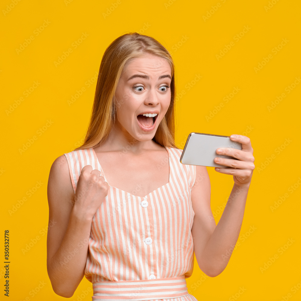 Emotional Teen Girl Rejoicing Success With Smartphone In Hands Emotional Teen Girl Rejoicing Success With Smartphone In Hands