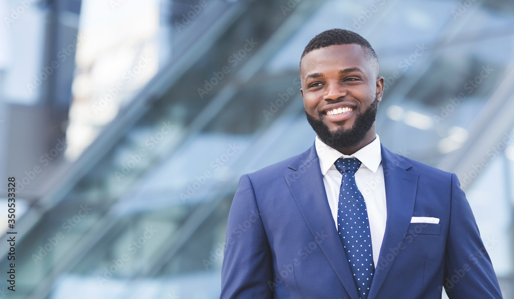 Fototapeta premium Happy African Entrepreneur Standing In Urban Area In City