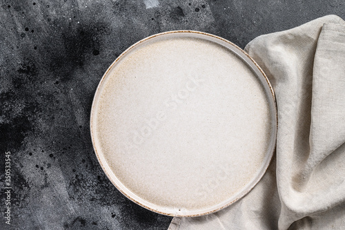 White empty round plate, restaurant background. Black background. Top view. Copy space.
