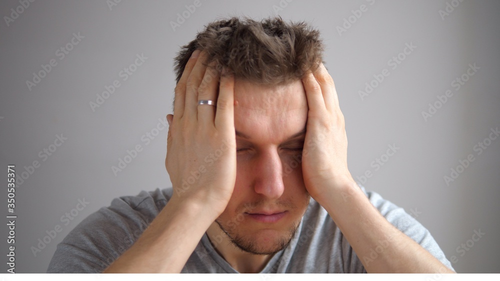 Stressed Young Man Squeezing Head With Hands, Suffering From Headache. Stressed Young Man Squeezing Head With Hands, Suffering From Headache.