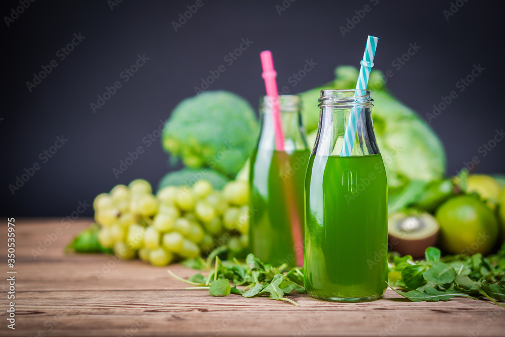 Vegetarian healthy food. Source of protein for vegetarians. Healthy eating: kiwi, grapes, lime, apple, broccoli, avocado, juice on dark background. Vegetarian healthy food. Source of protein for vegetarians. Healthy eating: kiwi, grapes, lime, apple, broccoli, avocado, juice on dark background.