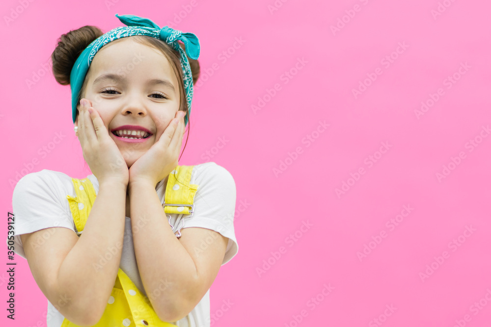 Attractive girl smiling on the pink background. Attractive girl smiling on the pink background.