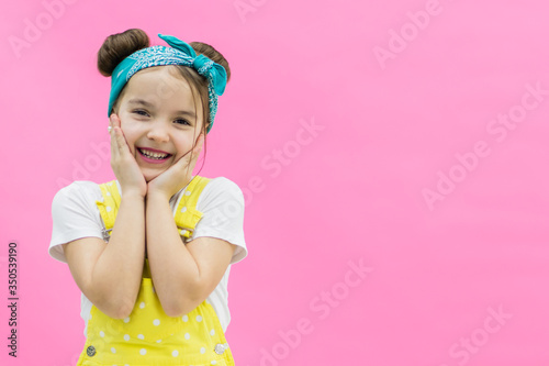 Daughter is smiling widely wearing white and yellow clothes.