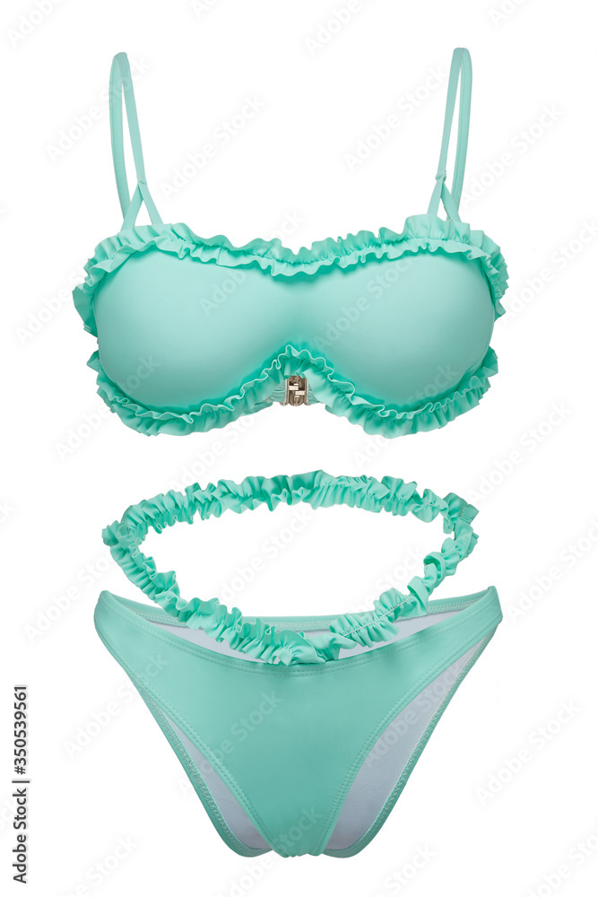 Detailed shot of a mint two-piece swimsuit consists of bikini and a tube bra with thin shoulder straps. The fashion swimming suit is decorated with ruffles and isolated on the white background. 