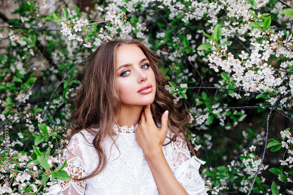 Portrait of beautiful natural woman in blossom spring park Portrait of beautiful natural woman in blossom spring park