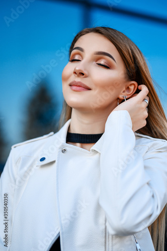 Attractive girl walking in the city in spring