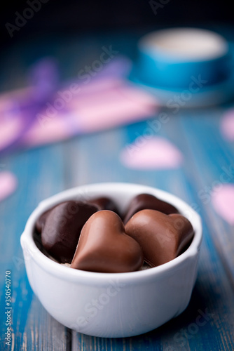 Valentines day chocolates in cup with defocused present