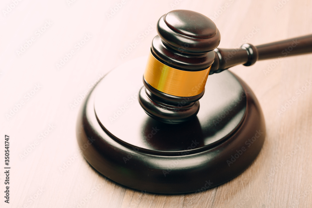 Symbol of law and justice on wooden table in lawyer office Symbol of law and justice on wooden table in lawyer office